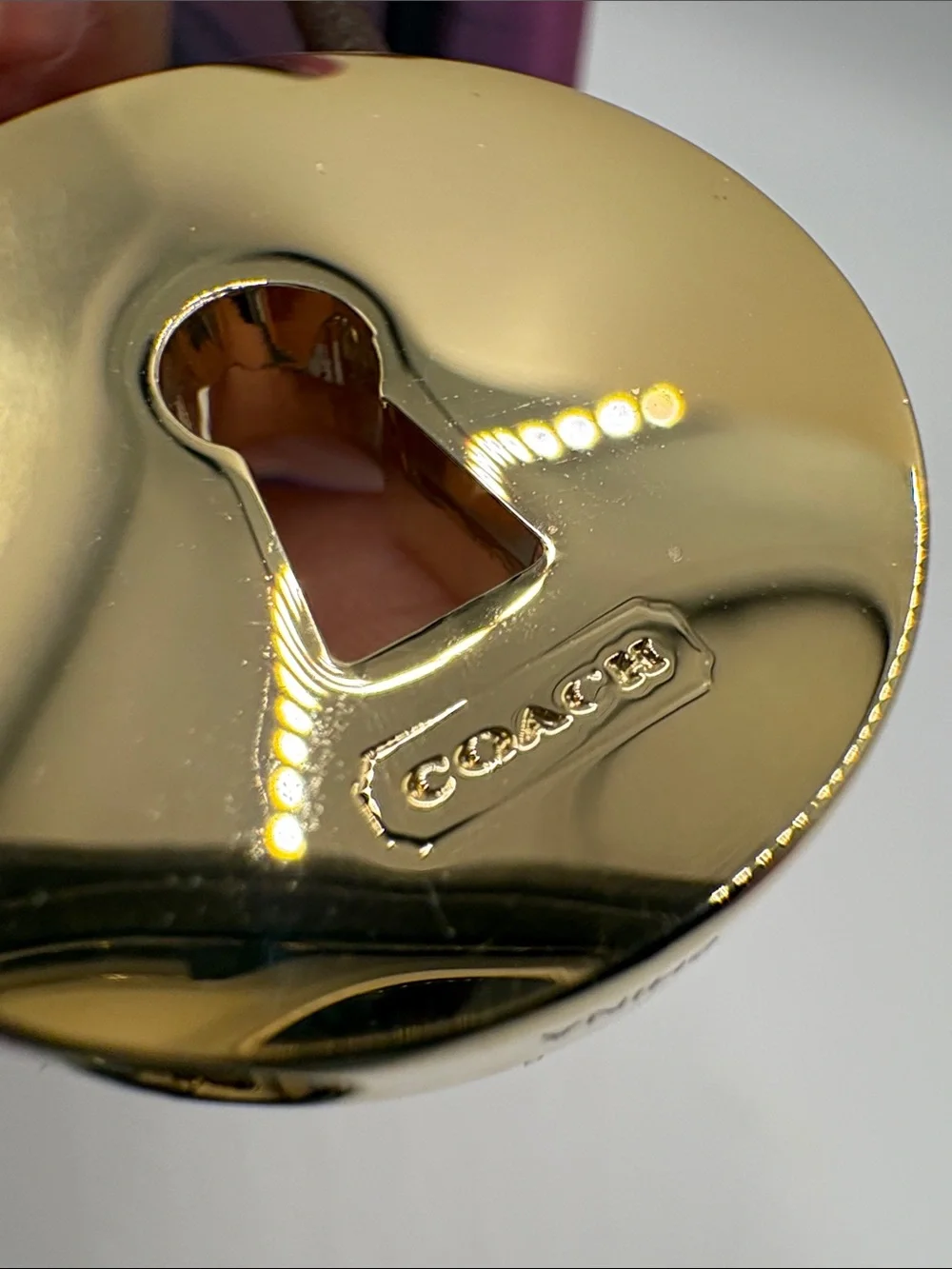 Coach Gold-Tone Padlock Charm on Brown Leather Loop
